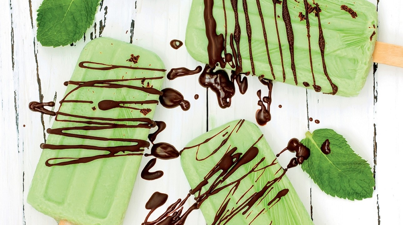 Green popsicles with chocolate sauce splatters