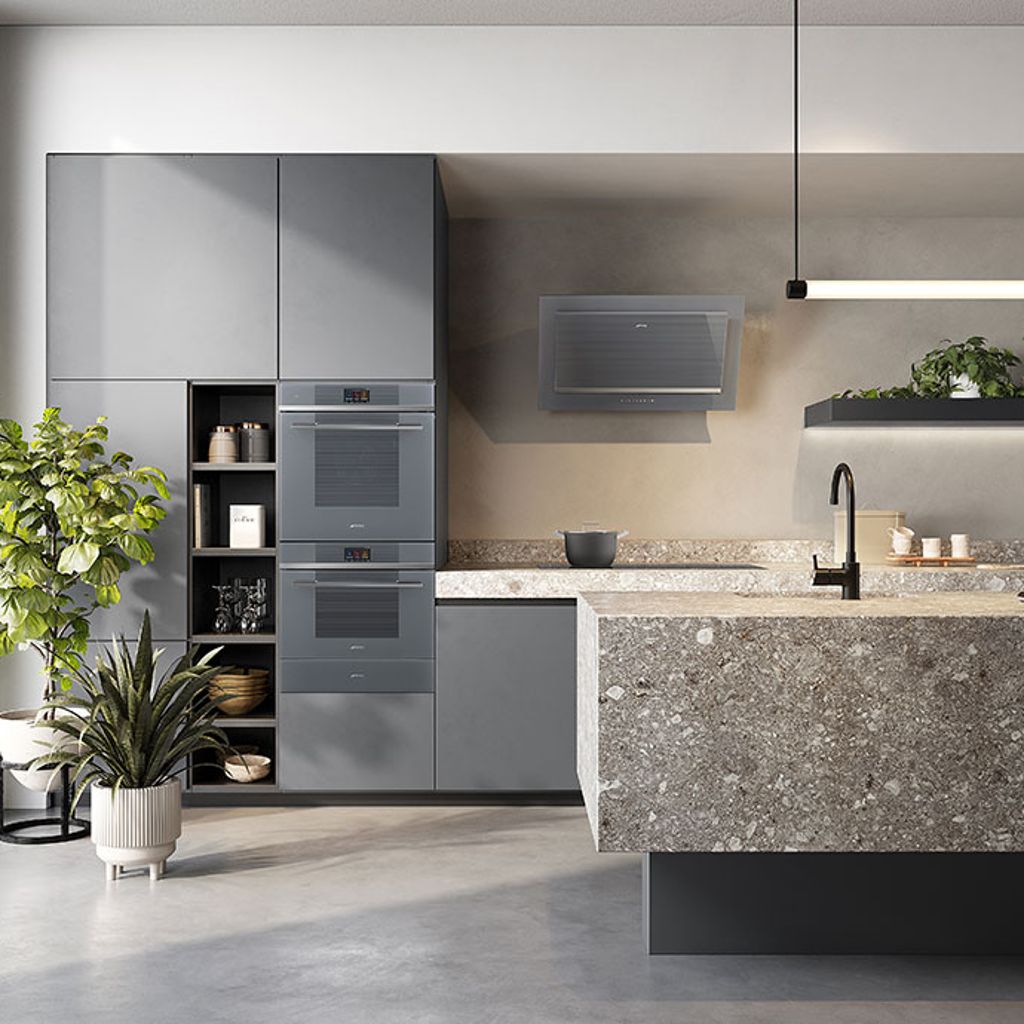 A contemporary kitchen with modern grey, handle-less units, and two of Smeg's built-in single ovens in a column arrangement