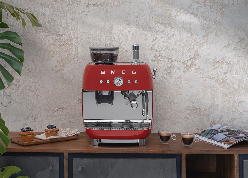 Red Espresso coffee machine with coffee and pastries
