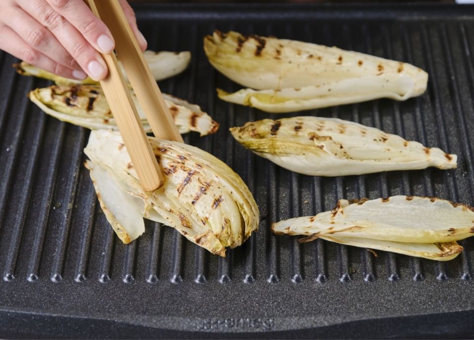 Endive with orange sauce, robiola and pistachios