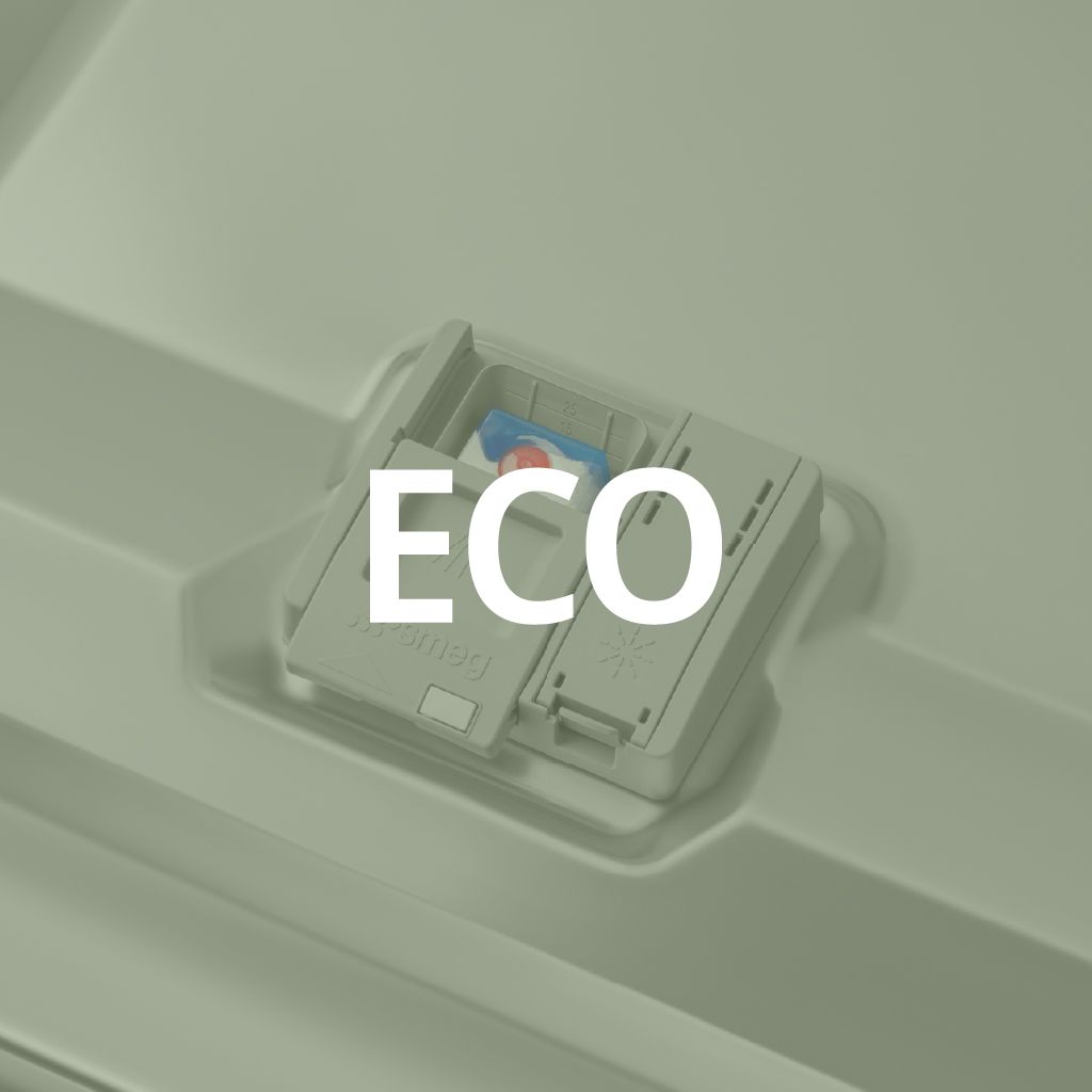 A dishwasher's open detergent dispenser with a colorful eco-friendly detergent tab inside