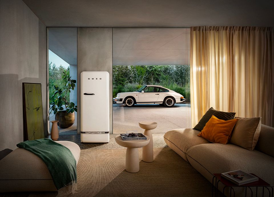 Modern and refined ambience with the Carrara White Collection with a Porsche and the Smeg Fridge