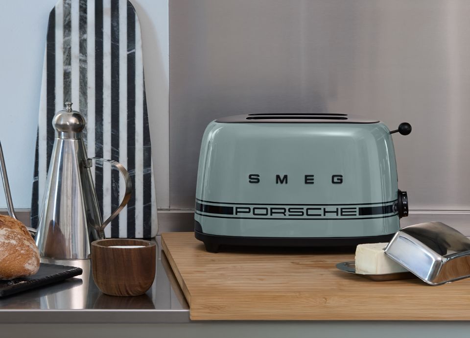 Porsche x SMEG Shade Green Toaster in a kitchen with a loaf of bread