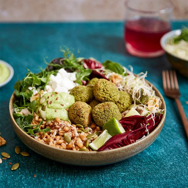 Buddha bowl with quinoa patties, broccoli stems and spinach
